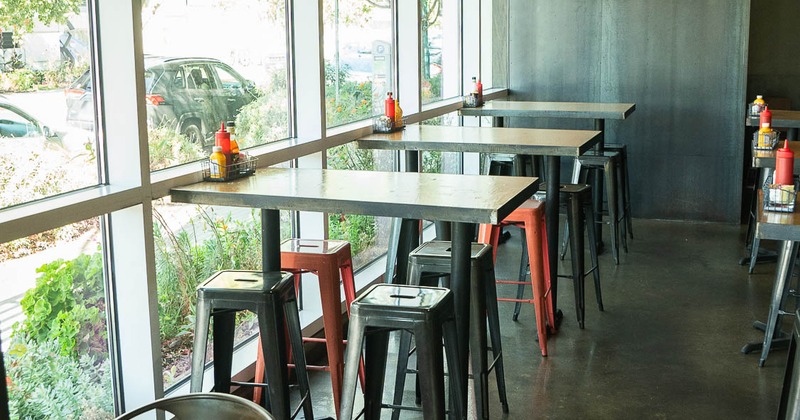 Interior, high tables and chairs near window