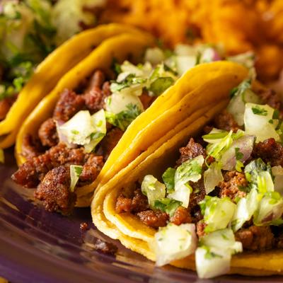 Street tacos filled with chopped meat, onions, and cilantro.