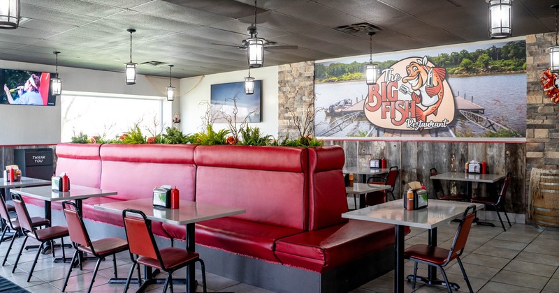 Interior, tables, chairs and red leather seating bench