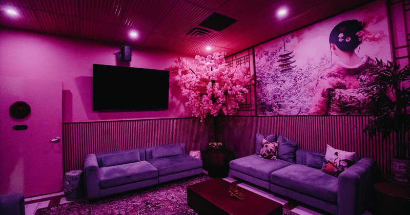 Lounge area with artificial cherry blossom trees, comfortable sofas and leather seating
