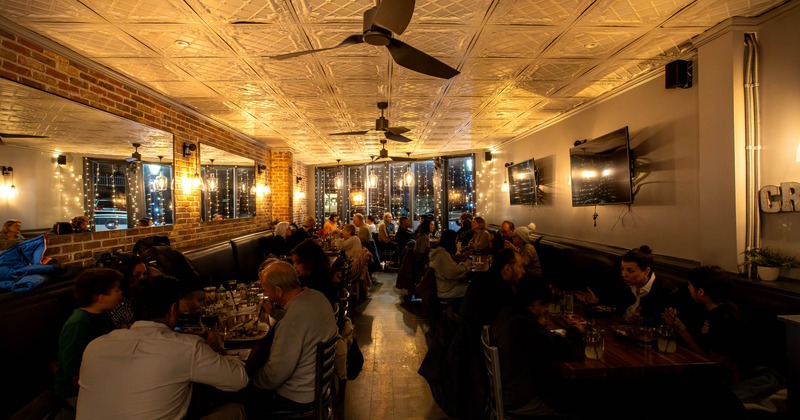 Interior, dining area, guests sitting and enjoying their food and drinks