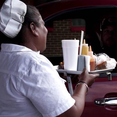 Curb server interacting with a patron.