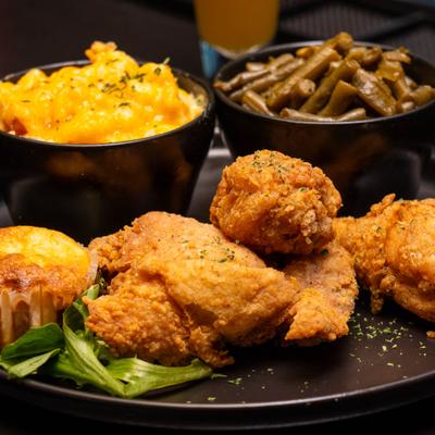 Fried chicken served with cornbread muffin, green beans and mac and cheese.
