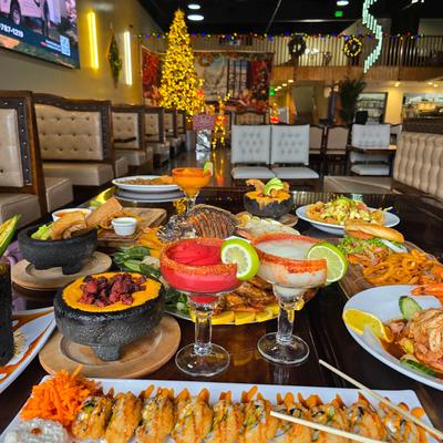 Elegant restaurant interior with holiday decor, a table spread with various dishes and drinks.