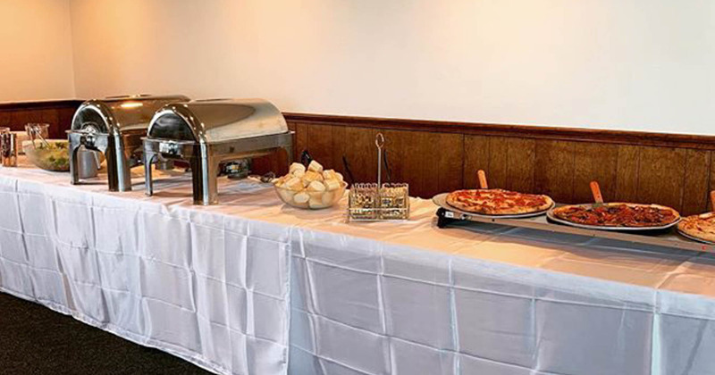 Interior, table with pizzas and cut bread