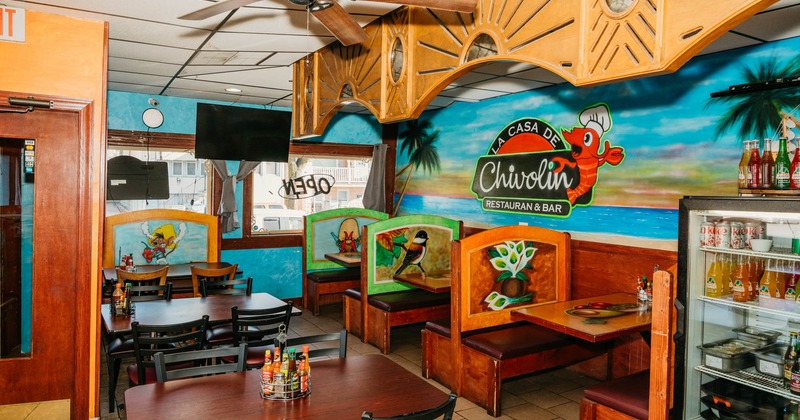 Interior, tables ready for guests, restaurant's logo on the wall