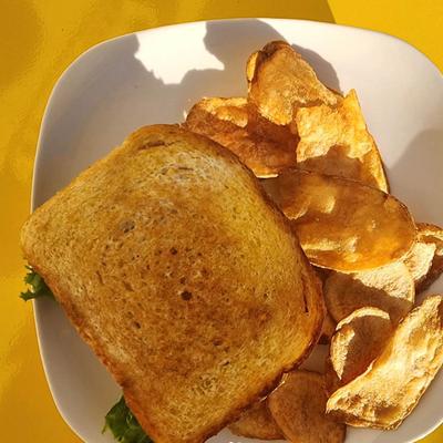 Chicken club and chips, top view.