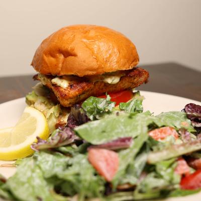 Blackened Salmon Sandwich with side salad.