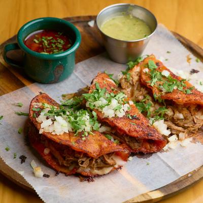 Birria Tacos with a side of beef broth.