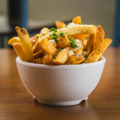 Greek Fries topped with parsley, Parmesan, and oregano.