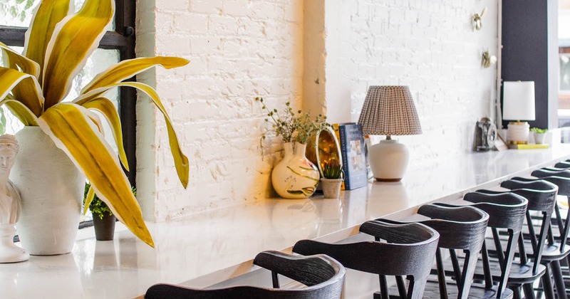Interior, wall table with decorations and bar chairs
