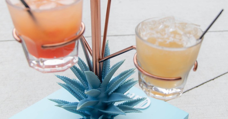 Flight of cocktails on a decorative stand with an agave plant motif