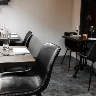 Interior, seating area, sleek black chairs and set tables