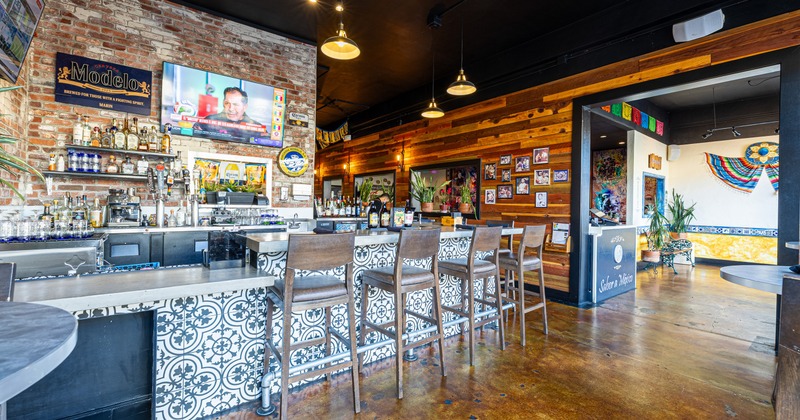 Interior, bar area with colorful tiles, brick wall