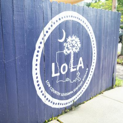 Restaurant's logo on a fence outside.