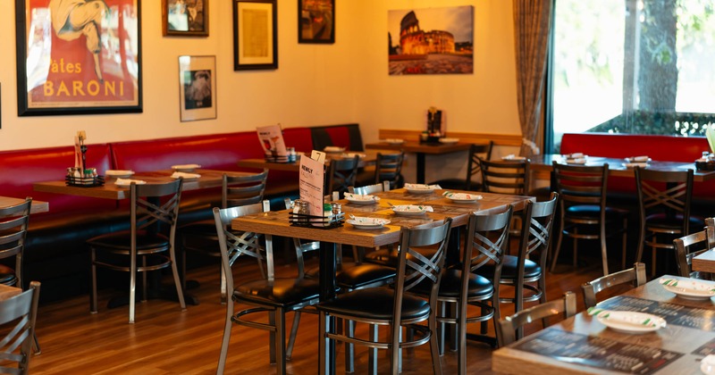 Interior, dining area, table for six, banquette bench with tables and chairs in the back