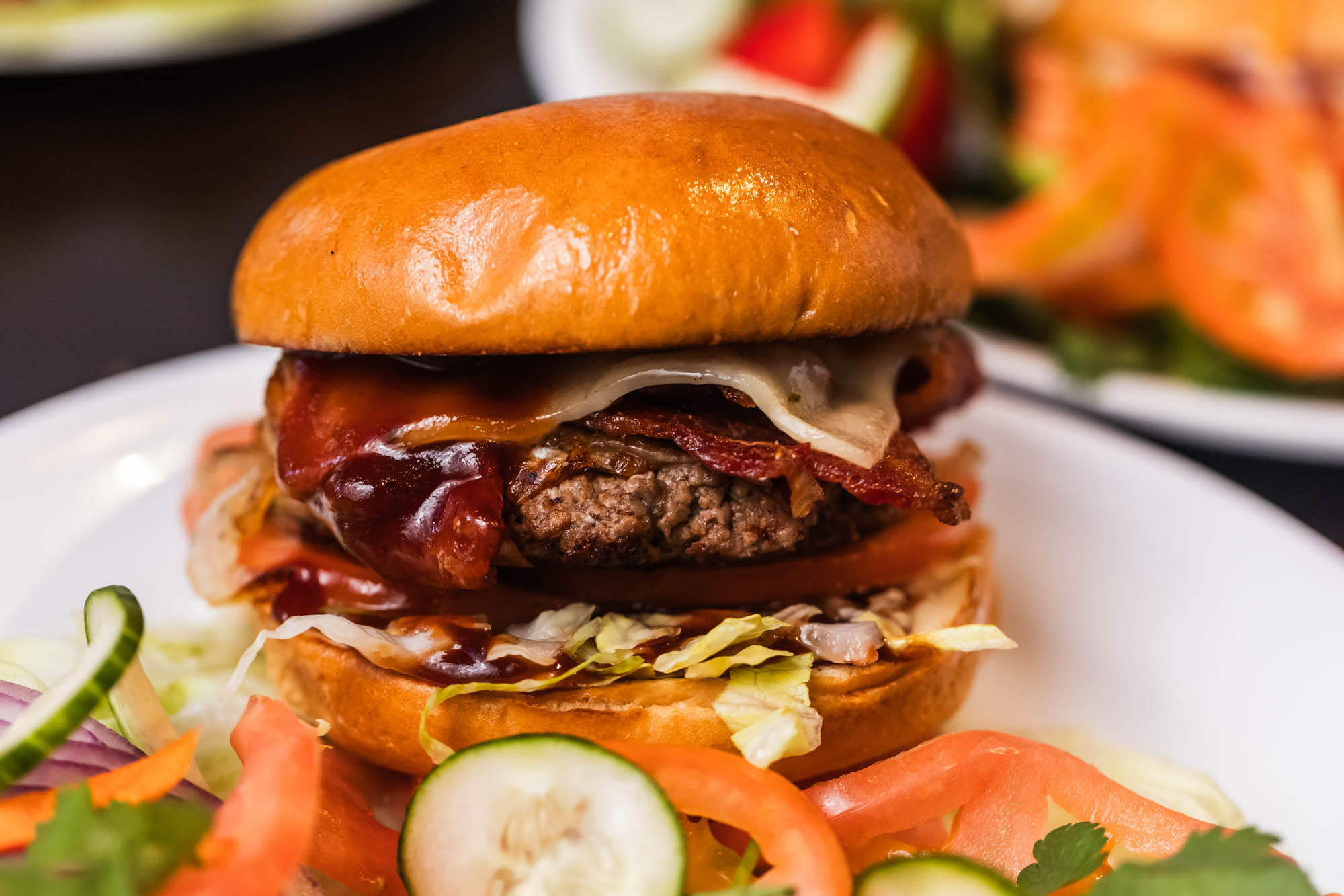 BBQ bacon cheeseburger with lettuce and tomato