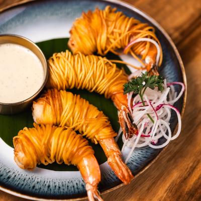 Angel Shrimp wrapped in noodles, served with shreded vegetables and a dip.