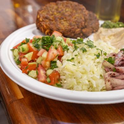 Latke Platter served with rice, onions, salad sauces and condiments.