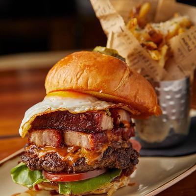 Wake and Bac’n burger, with pork belly, white cheddar, egg, onion jam, sauce, lettuce, and tomato.