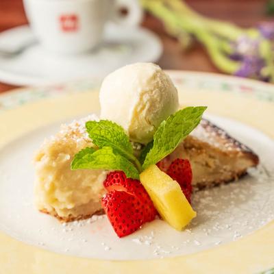 Torta della nonna paired with vanilla ice cream, fruit and mint garnish.