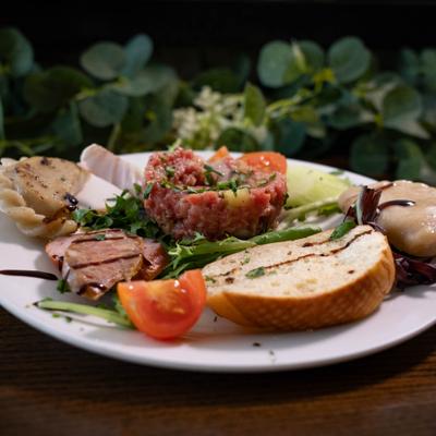 Tartar salad with  bread on white plate.