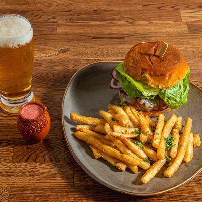 California Burger  with seasoned fries, a glass of beer and Mexican Candy shot.