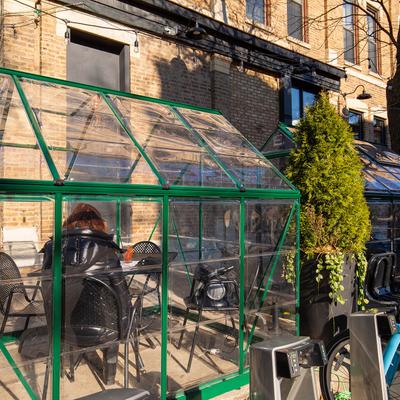 Outdoor winter dining tent, guest sitting, back view