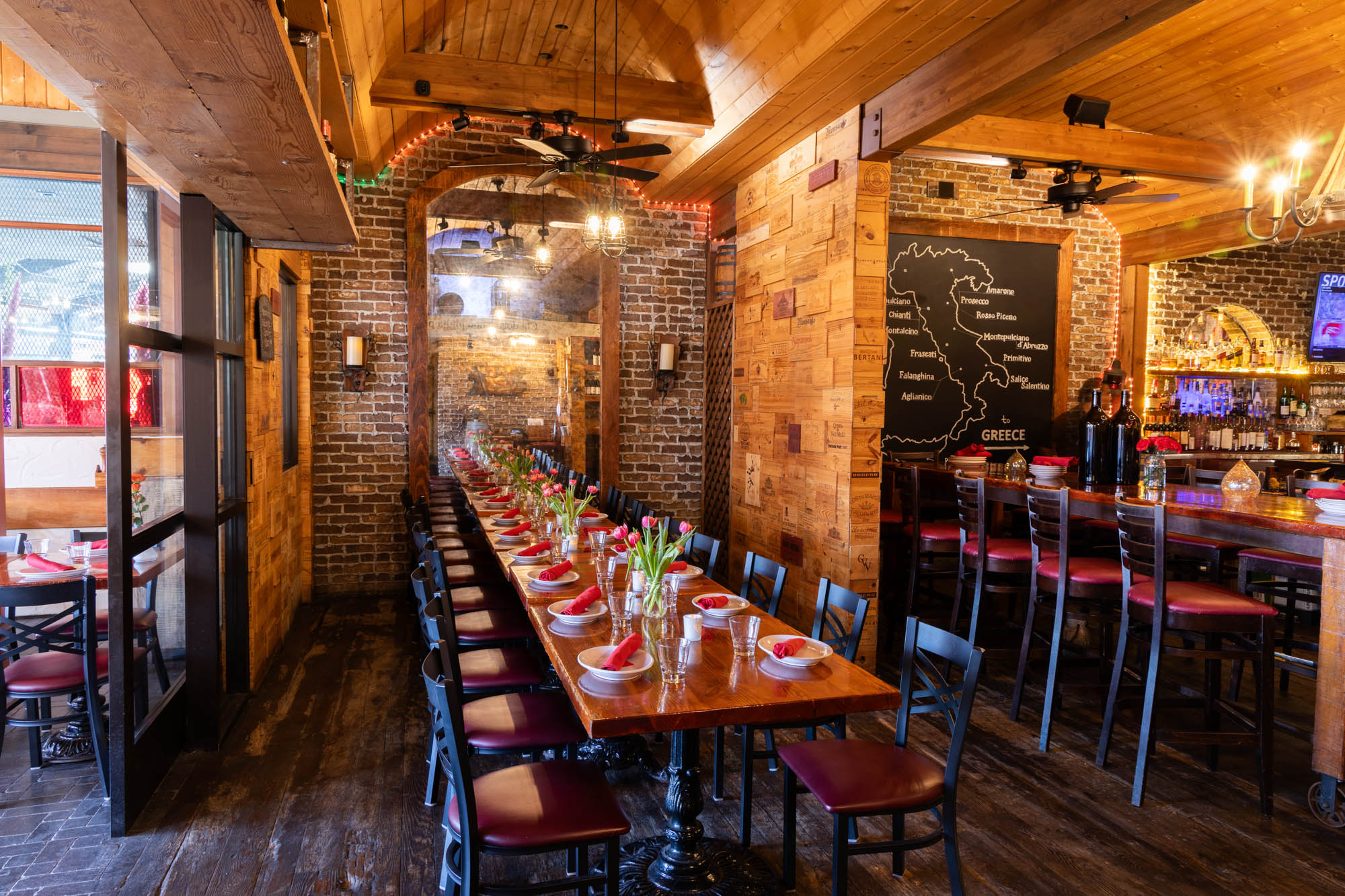 Interior with brick and wooden walls, long table, and a wine map