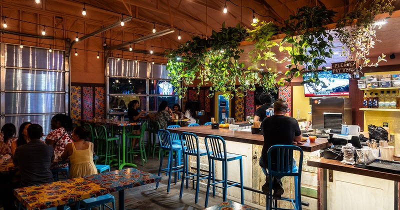 Interior, bar and seating area with guests