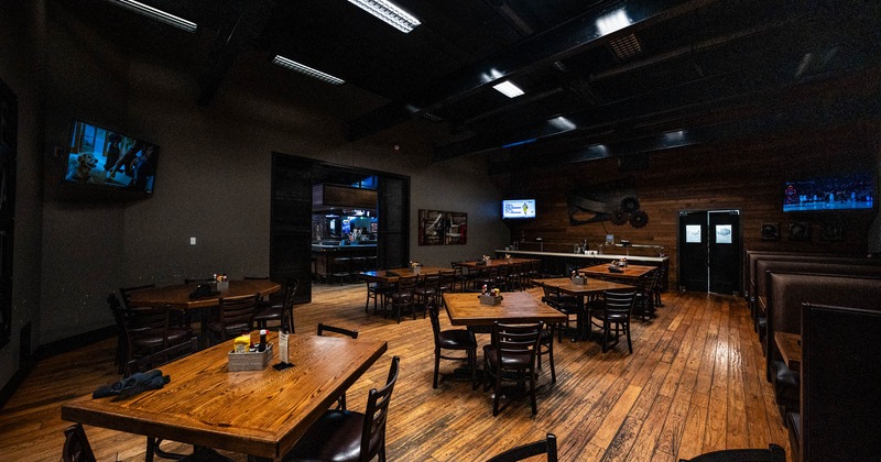 Interior, tables ready for guests, TVs on the wall