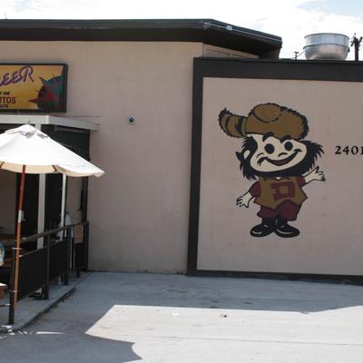 The Pioneer Bar exterior, outdoor seating and logo mural