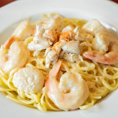 Seafood medley on top of pasta.