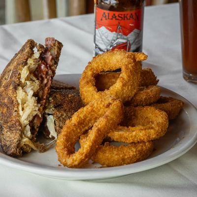 Reuben Sandwich paired with onion rings.