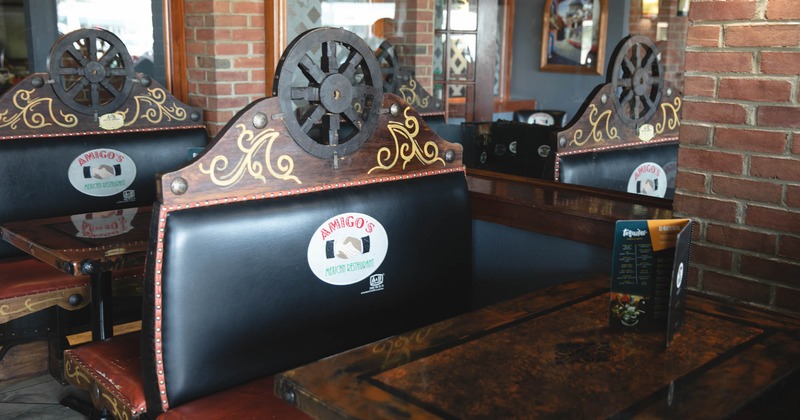 A booths with wooden horse wagon wheel detail on it