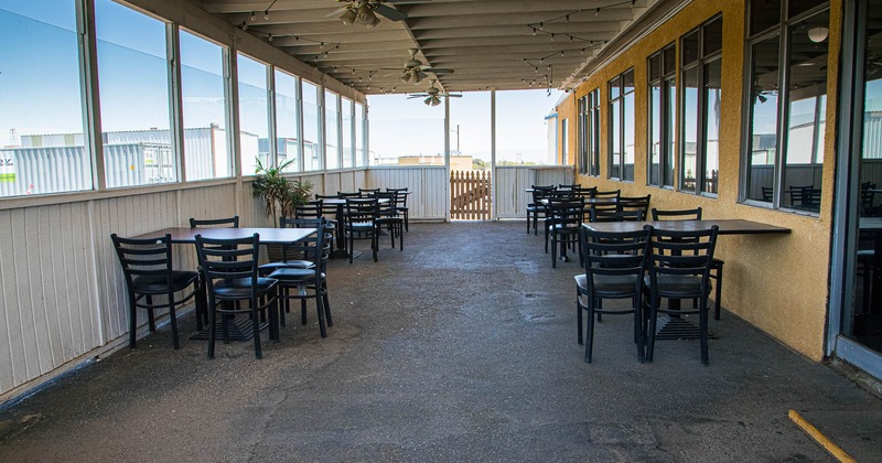 Exterior, covered patio with tables and chairs