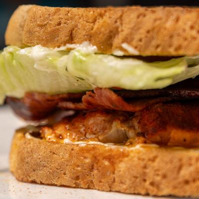 Salmon BLT sandwich, close-up.