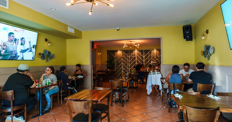Casual restaurant interior with diners sitting at wooden tables