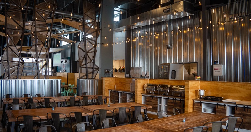 Interior, dining area, wood coated serving station, large abstract metal space divider