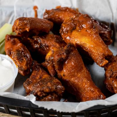 Buffalo chicken wings served with celery, carrots and sauce for dipping