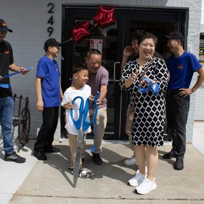 Opening ceremony featuring cutting a ribbon with giant scissors.