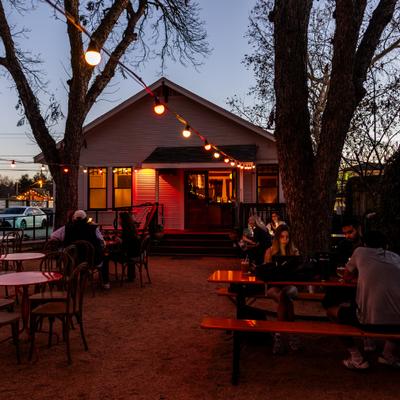 Outdoor seating with string lights at dusk.