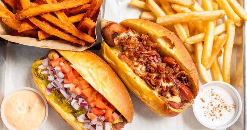 Combo plate with Bacon Cheese Dog, Classic Dog, fries and  sauces