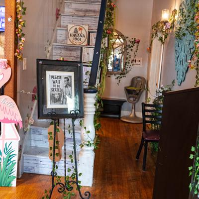Interior decorations with flamingo cutout, plants, and vintage-style elements.