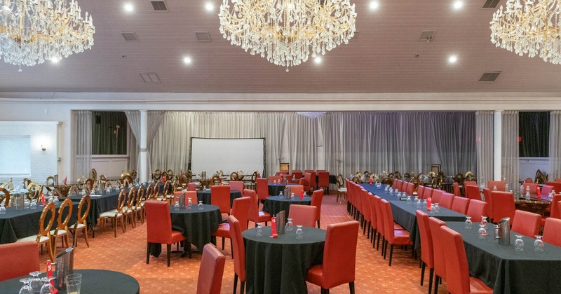 Interior, open space banquette room, tables for various number of guests, chandeliers