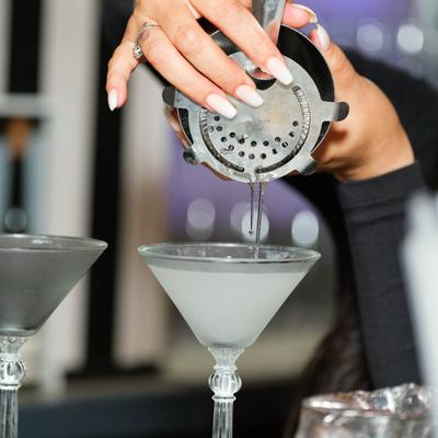 Person pouring drink in the glass.