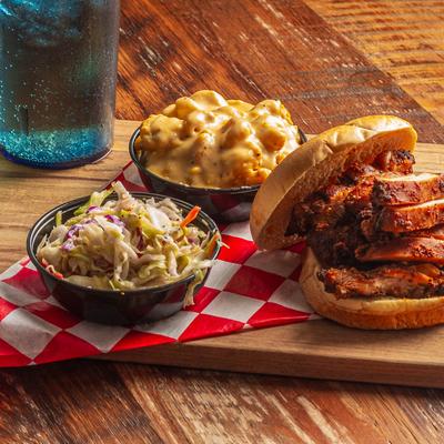 Chicken sandwich and side dishes.