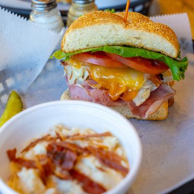 Woodrow sandwich with bacon and mashed potatoes on the side