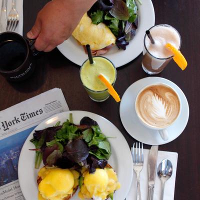 Eggs Benedict and goat cheese and spinach omelet served with coffee drinks and fresh juices.