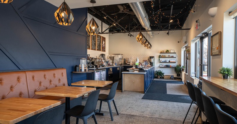 Interior, seating area, bar and cafe entrance in the back, modern stylish chandeliers